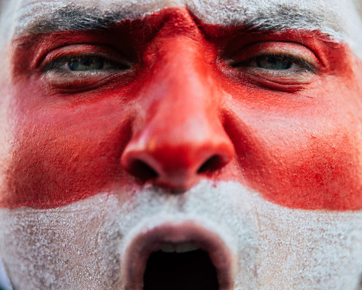Protester with white-red colooured face